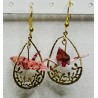 Boucles d'oreilles. Grue dans anneau fleuri - Rose